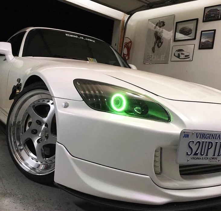 Close-up of green LED headlight halo ring installed on a Honda S2000.