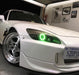 Close-up of green LED headlight halo ring installed on a Honda S2000.