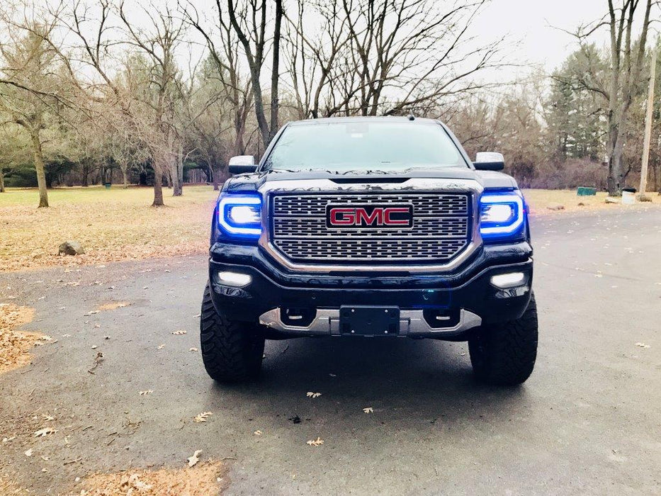 Front view of a GMC Sierra with blue headlight DRLs.