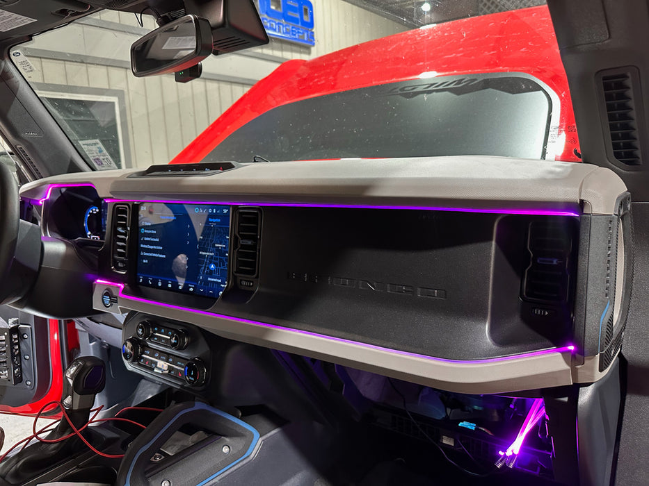 Dashboard of a Ford Bronco, with purple fiber optic lighting installed.