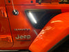 Close-up of Sidetrack™ LED Lighting System installed on a Jeep, with white LEDs on.