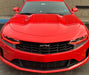 Front end of a red Chevrolet Camaro with red headlight DRLs.