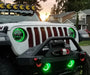 Front view of white jeep outdoors with green halos and fog lights