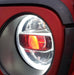 Close-up of a Jeep Headlight with red demon eye projector.
