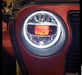 Close-up of jeep headlight with red demon eye projector