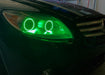Close-up on the headlight of a Mercedes Benz CL 500 with green LED halo rings.
