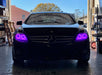 Front end of a Mercedes Benz CL 550 with purple LED headlight halo rings.