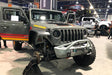 Grey Jeep in a showroom, with Oculus Headlights installed.