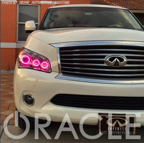Front end of an Infiniti QX56 with pink LED headlight halo rings installed.