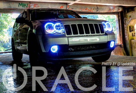Front end of a Jeep Grand Cherokee with white LED headlight and fog light halos.