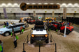 High angled photo of a Bronco showroom. In the center is a white Ford Bronco with Integrated Windshield Roof LED Light Bar System installed.