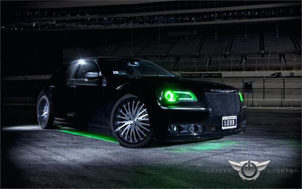 Three quarters view of a Chrysler 300C with green LED halo rings and DRLs.