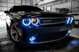 Front end of a Dodge Challenger with white LED headlight and fog light halo rings.