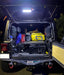 Rear end of a Jeep with Cargo LED Light Module installed, illuminating the rear cargo area.