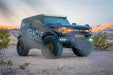 ORACLE Lighting wrapped Ford Bronco in the desert with Integrated Windshield Roof LED Light Bar System installed.