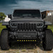 A Jeep parked in the grass, equipped with LED Integrated Skid Plate and Vector Grill.