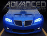 Front end of a Pontiac G8 with blue LED headlight halo rings installed.