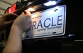 Man actively installing license plate LED light