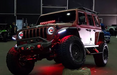 Red Jeep Wrangler JL with matching red demon eye projectors.
