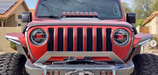 Front end of a Jeep Gladiator with red demon eye projectors.