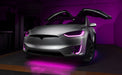 Silver Tesla Model X with pink headlight and fog light DRLs.
