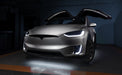Silver Tesla Model X with white headlight and fog light DRLs.