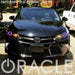Front end of a Toyota Camry with purple LED headlight halo rings installed.