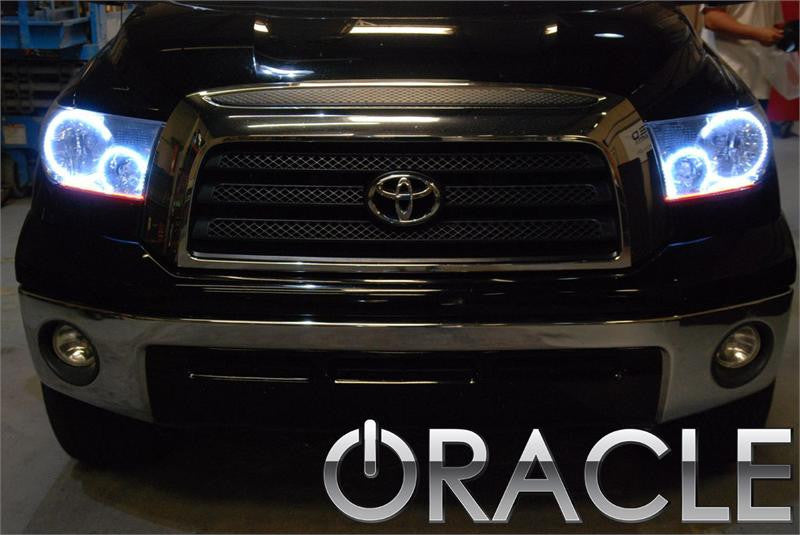 Front end of a Toyota Tundra with white LED headlight halo rings installed.