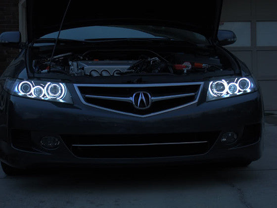 Front end of an Acura TSX with white LED headlight halo rings installed.
