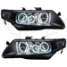 Acura TSX headlights with white LED halo rings.
