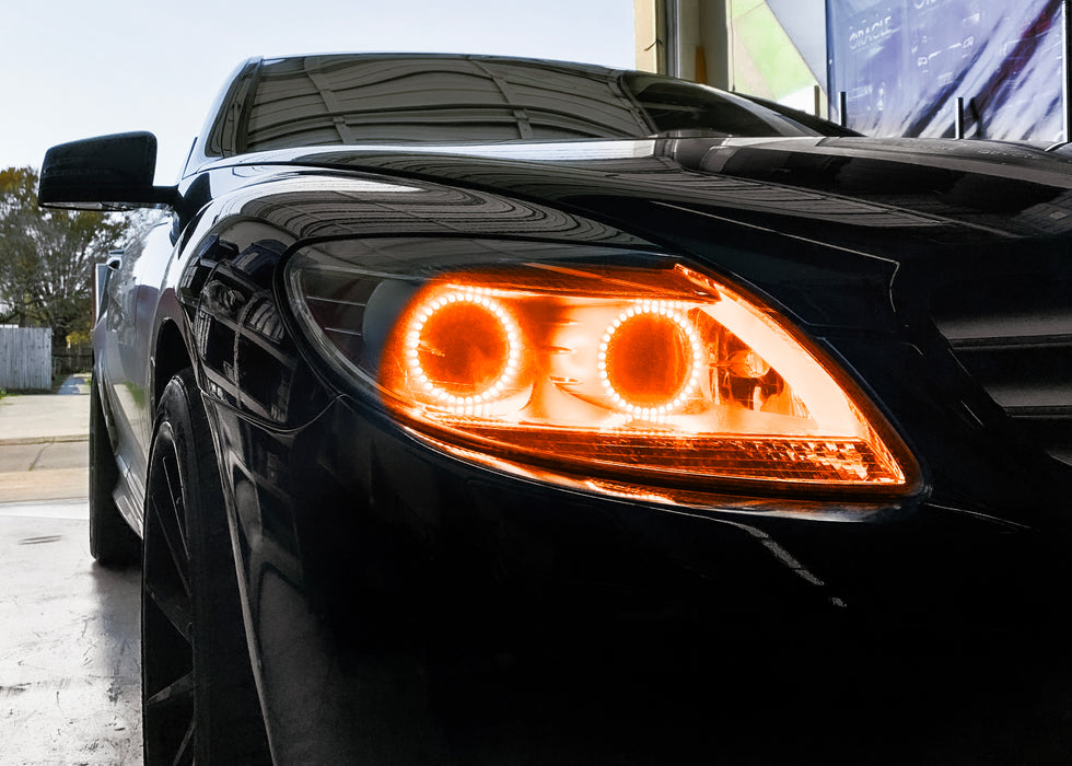 Close-up on the headlight of a Mercedes Benz CL 500 with amber LED halo rings.