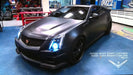 Three quarters view of a Cadillac CTS-V Coupe with white LED headlight halo rings installed.