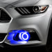 Close-up on the front bumper of a silver Ford Mustang equipped with blue fog light halos.