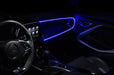 Car interior with blue fiber optic lighting installed on the dashboard.