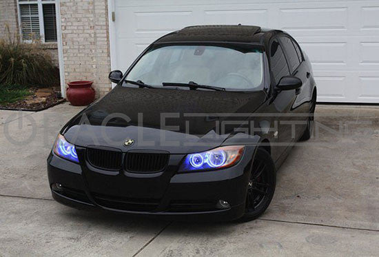 Front view of a BMW 3 Series with blue LED headlight halo rings installed.
