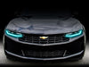 Front end of a Chevrolet Camaro with aqua headlight DRLs.