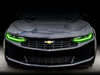 Front end of a Chevrolet Camaro with green headlight DRLs.