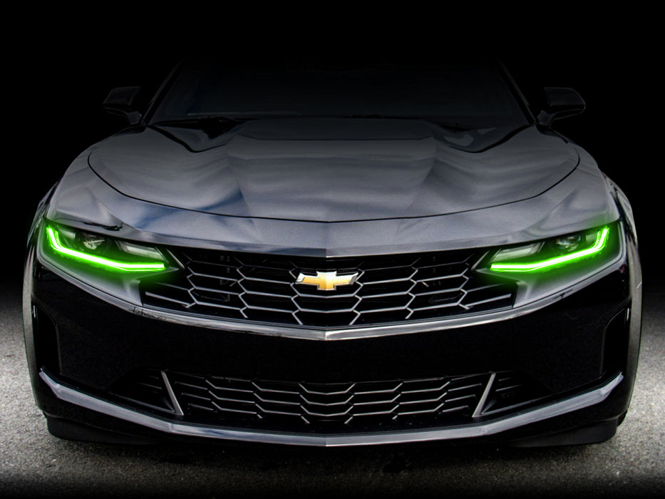Front end of a Chevrolet Camaro with green headlight DRLs.