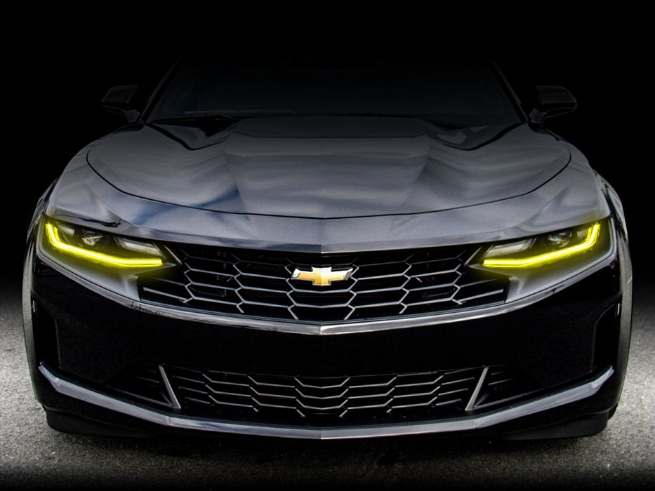 Front end of a Chevrolet Camaro with yellow headlight DRLs.