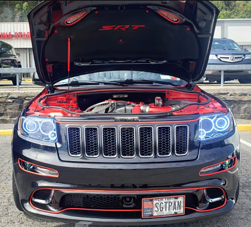 Front end of a Jeep Grand Cherokee with white LED headlight halo rings installed.
