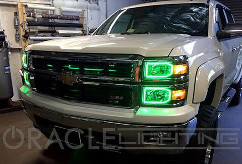 Three quarters view of a Chevrolet Silverado with green LED headlight halo rings installed.