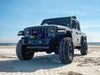 Three quarters view of a Jeep Gladiator JT on the beach, with Oculus Headlights installed.