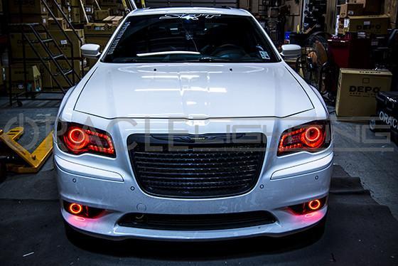 Front end of a Chrysler with red LED headlight and fog light halo rings.