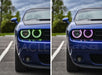 Two views of a Dodge Challenger, one with green halo headlights and one with purple halo headlights.
