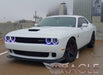 Three quarters view of a white Dodge Challenger with white LED headlight and fog light halo rings installed.