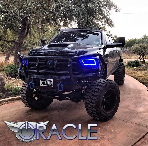 Front view of a black Dodge Ram with blue LED headlight halo rings.