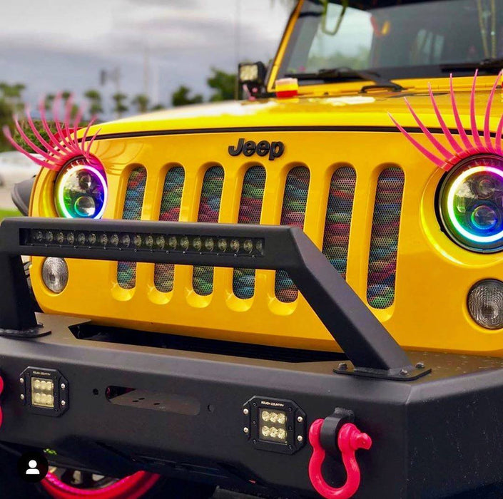 Close-up on yellow jeep gril with dynamic colorshift 7" headlights and eyelashes