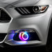 Close-up on the front bumper of a silver Ford Mustang equipped with rainbow fog light halos.