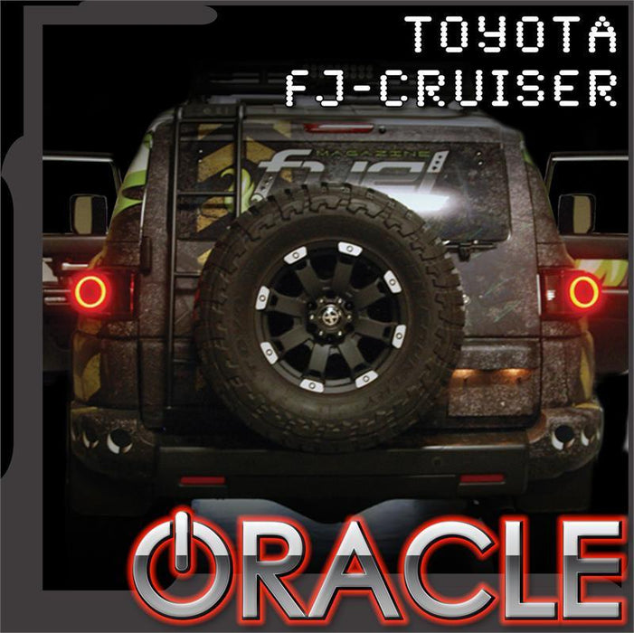 Rear view of a Toyota FJ Cruiser with glowing tail light halos. ORACLE Lighting logo in bottom corner