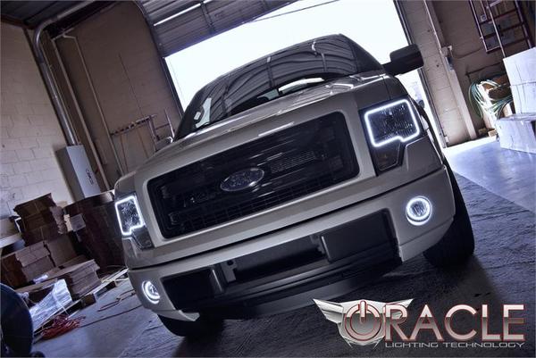 Front view of a Ford F-150 with white LED headlight and fog light halos.
